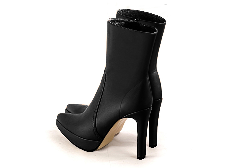 Satin black women's ankle boots with a zip on the inside. Tapered toe. Very high slim heel with a platform at the front. Rear view - Florence KOOIJMAN